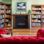 Burpengary Private Library Couch with Bookshelves next to a Fireplace - Narrow View