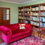 Burpengary Private Library Entrance Seen from the Inside with Couch and Bookshelves