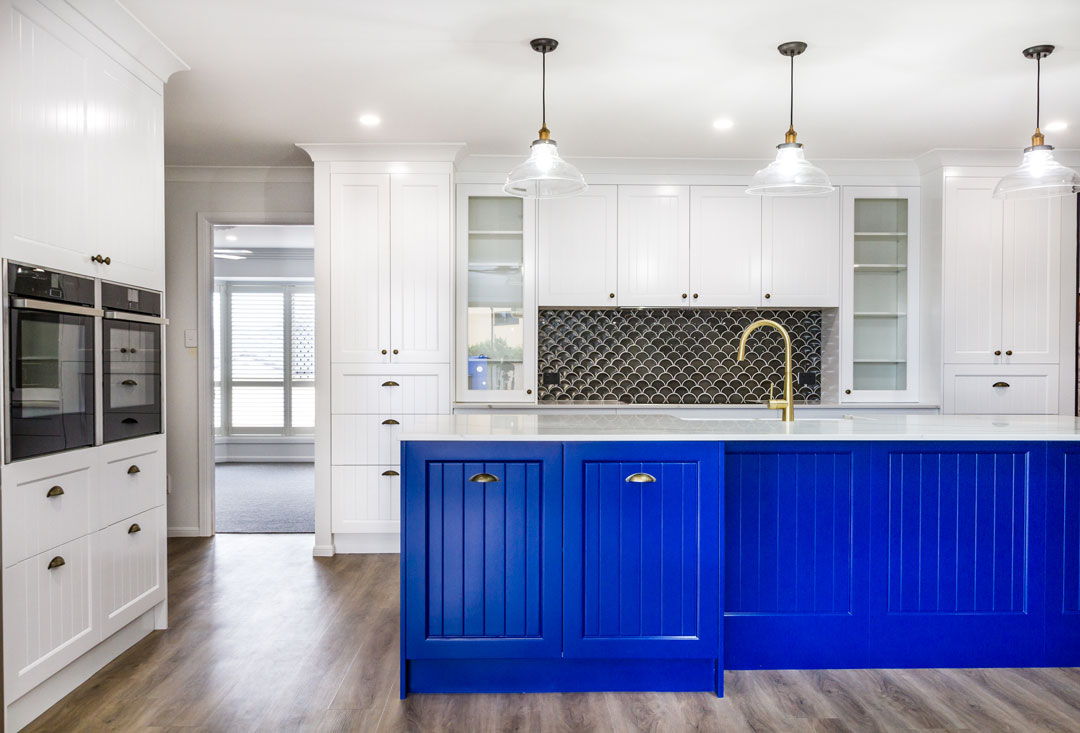 Queenslander style kitchen, newly renovated with blue kitchen cabinetry and matching high end hardware