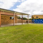 A perfectly manicured lawn and backyard pool